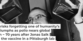 Dr. Jonas Salk displays his polio vaccine, which he developed in a University of Pittsburgh laboratory. Bettmann/Bettmann Collection via Getty Images